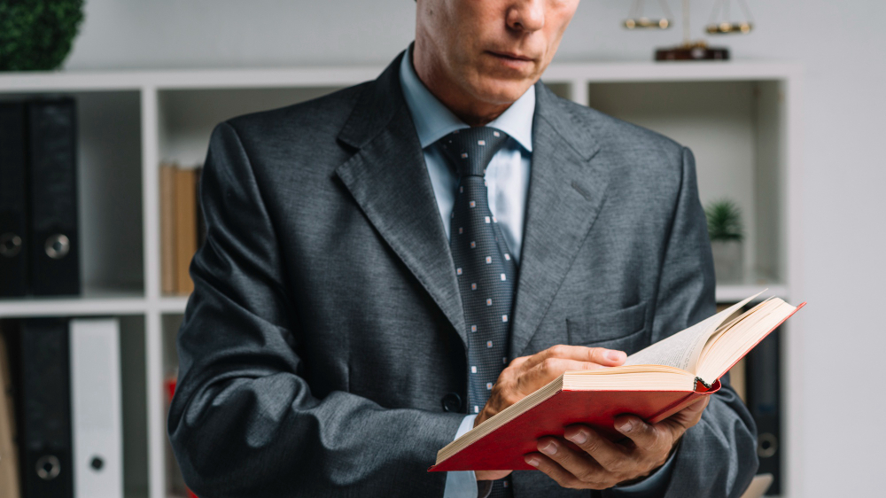 Glasgow lawyer looking at law book