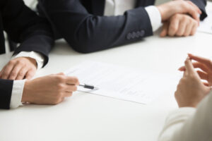 lawyers in Glasgow having a meeting with client over documents